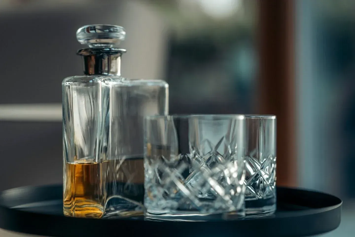 Close-up of a crystal whisky decanter and glasses, highlighting a luxury Scottish whisky tasting experience.