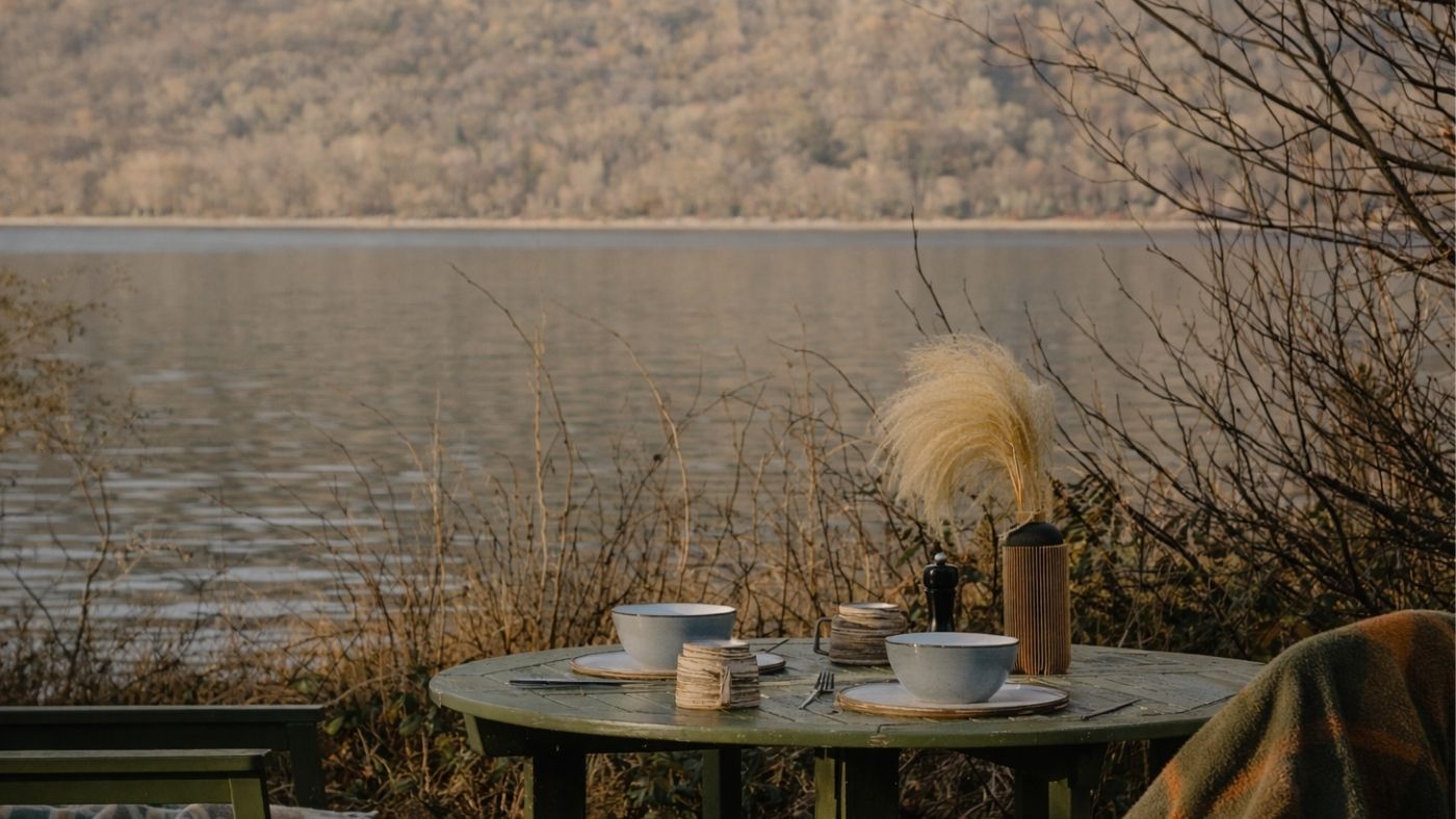 Luxury designer outdoor table set beside the loch at an off grid cabin retreat
