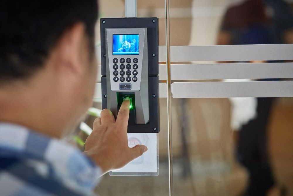 Young Man Push Finger Down on The Electronic Control — CTS Locksmiths in Sunshine Coast, QLD