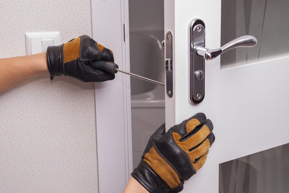 Man Repair The Door Lock in The Room — CTS Locksmiths in Maroochydore, QLD
