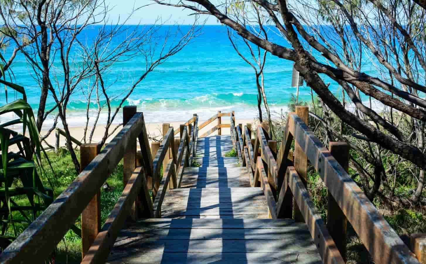 A Wooden Walkway Leading to a Beach — CTS Locksmiths in Kawana, QLD