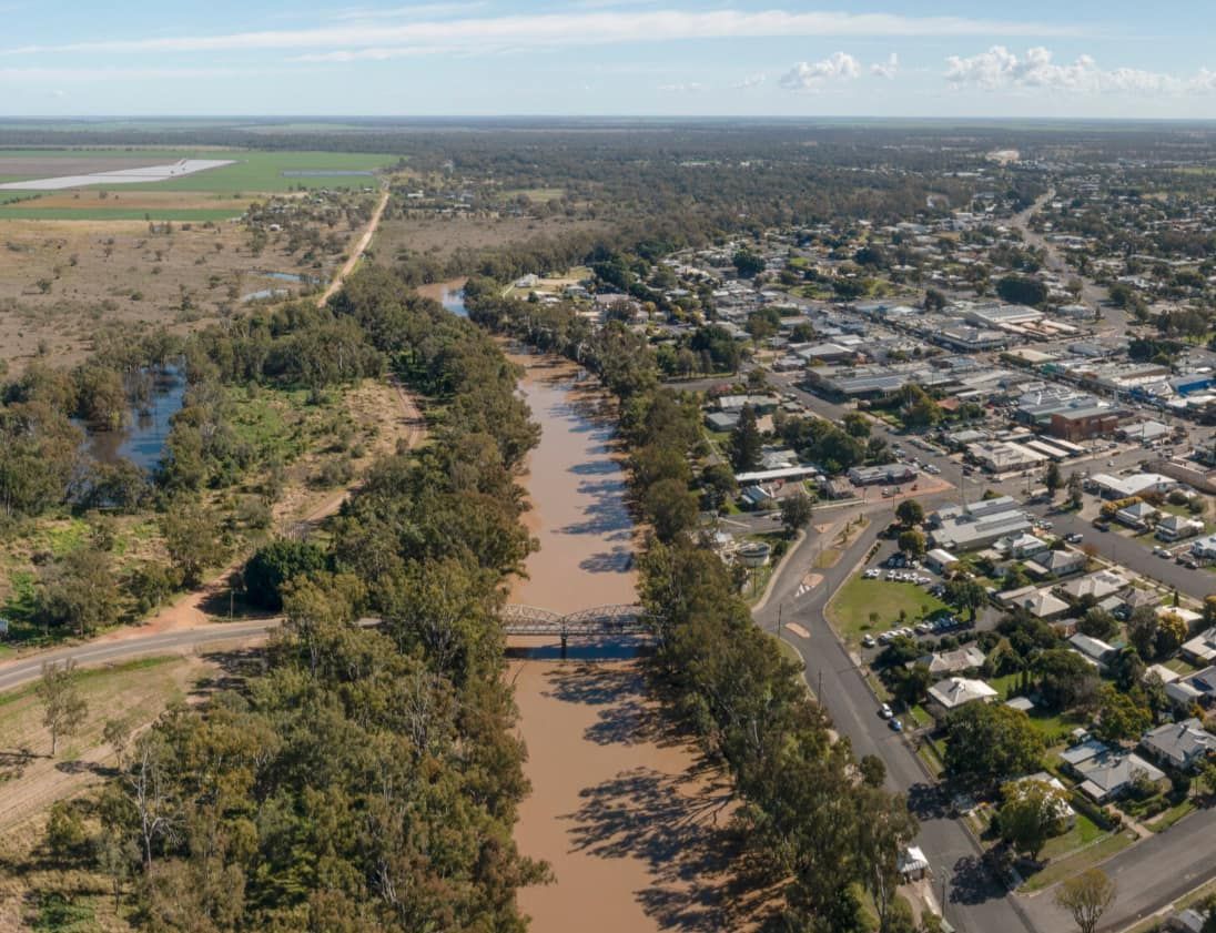 An Aerial View of a River Surrounded by Trees and a City — CTS Locksmiths in Aura, QLD