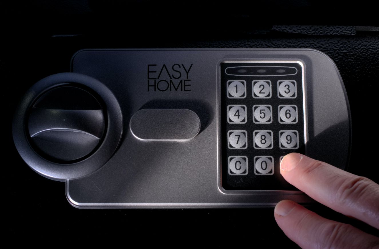 Black Safe With Hand Pressing — CTS Locksmiths in Sunshine Coast, QLD