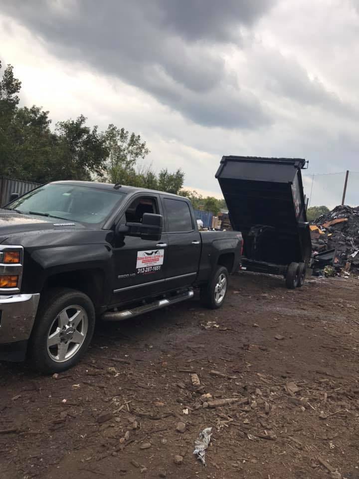 Black Pickup Truck with Trailer — Markham, IL — Duenas Roofing & Gutters Inc