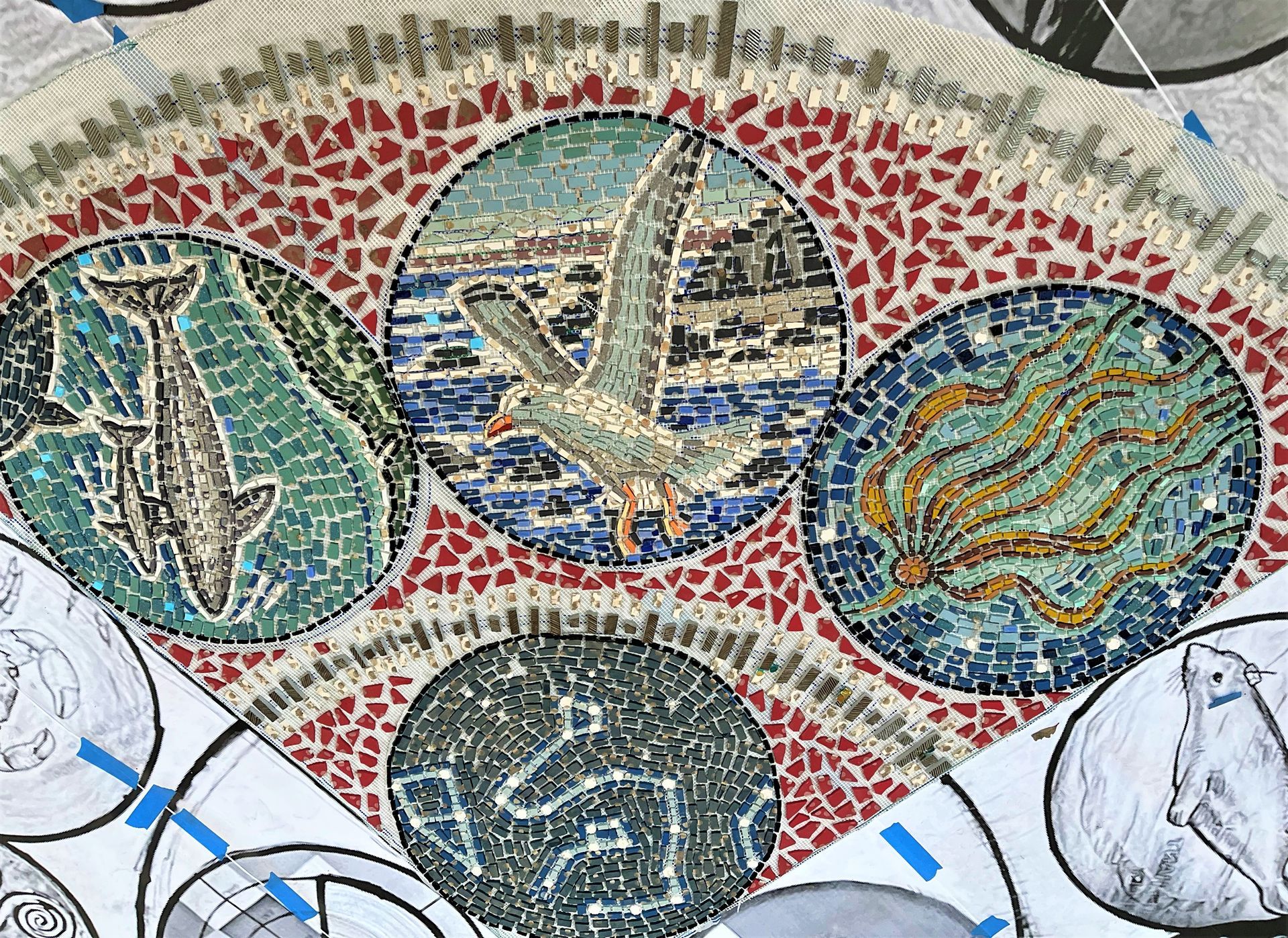 A mosaic with seagulls and dolphins on it