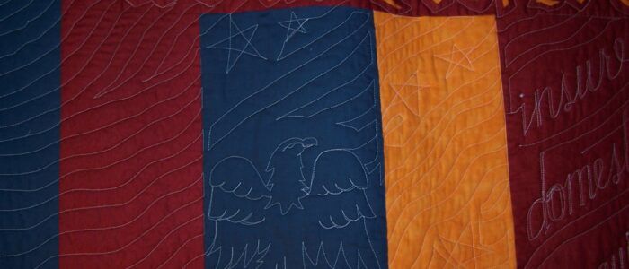 A close up of a red , blue and orange striped fabric.