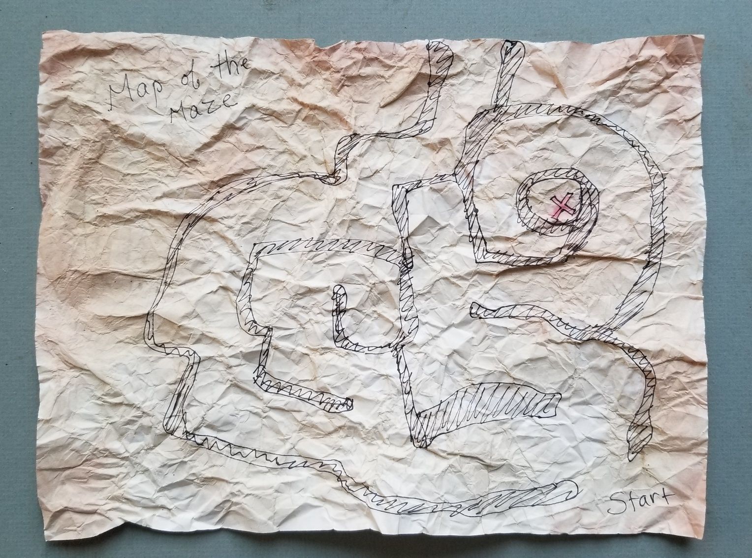 A piece of crumpled paper with a drawing on it