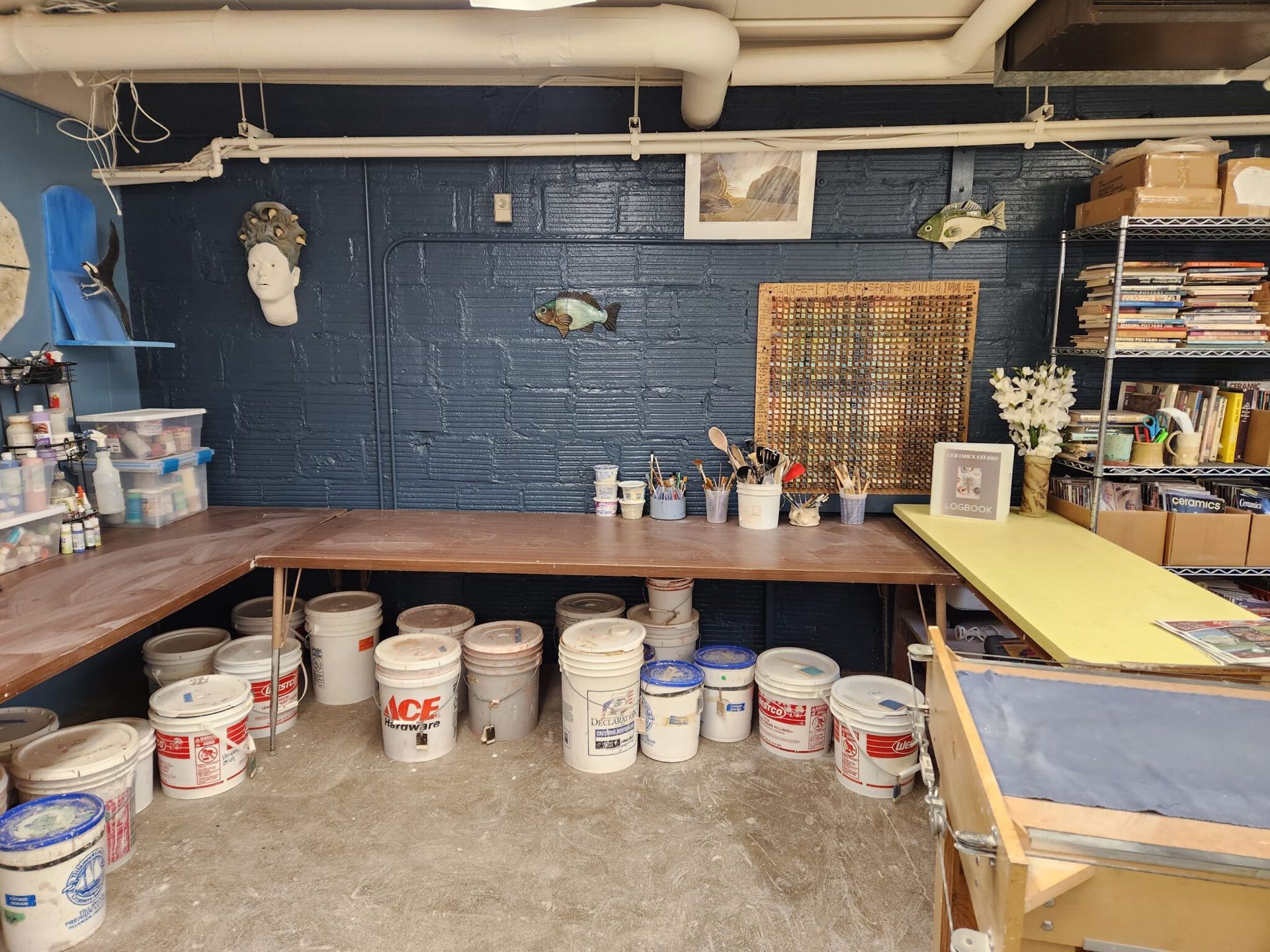 A room filled with buckets of paint and a table