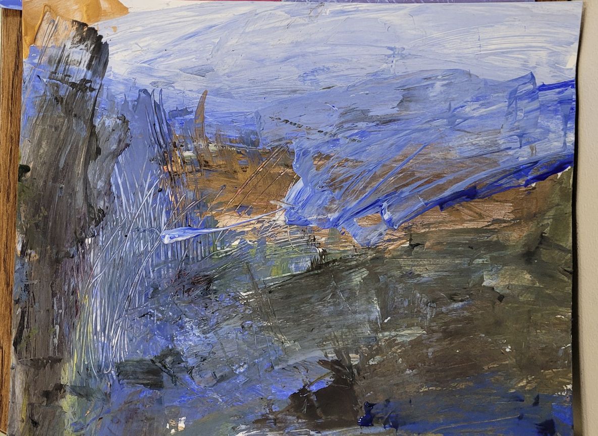 A close up of a painting on a canvas on a table.