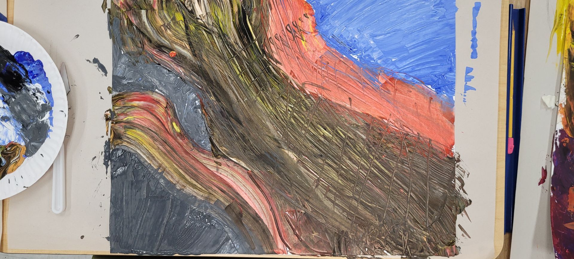 A close up of a painting on a table with a palette and brushes.