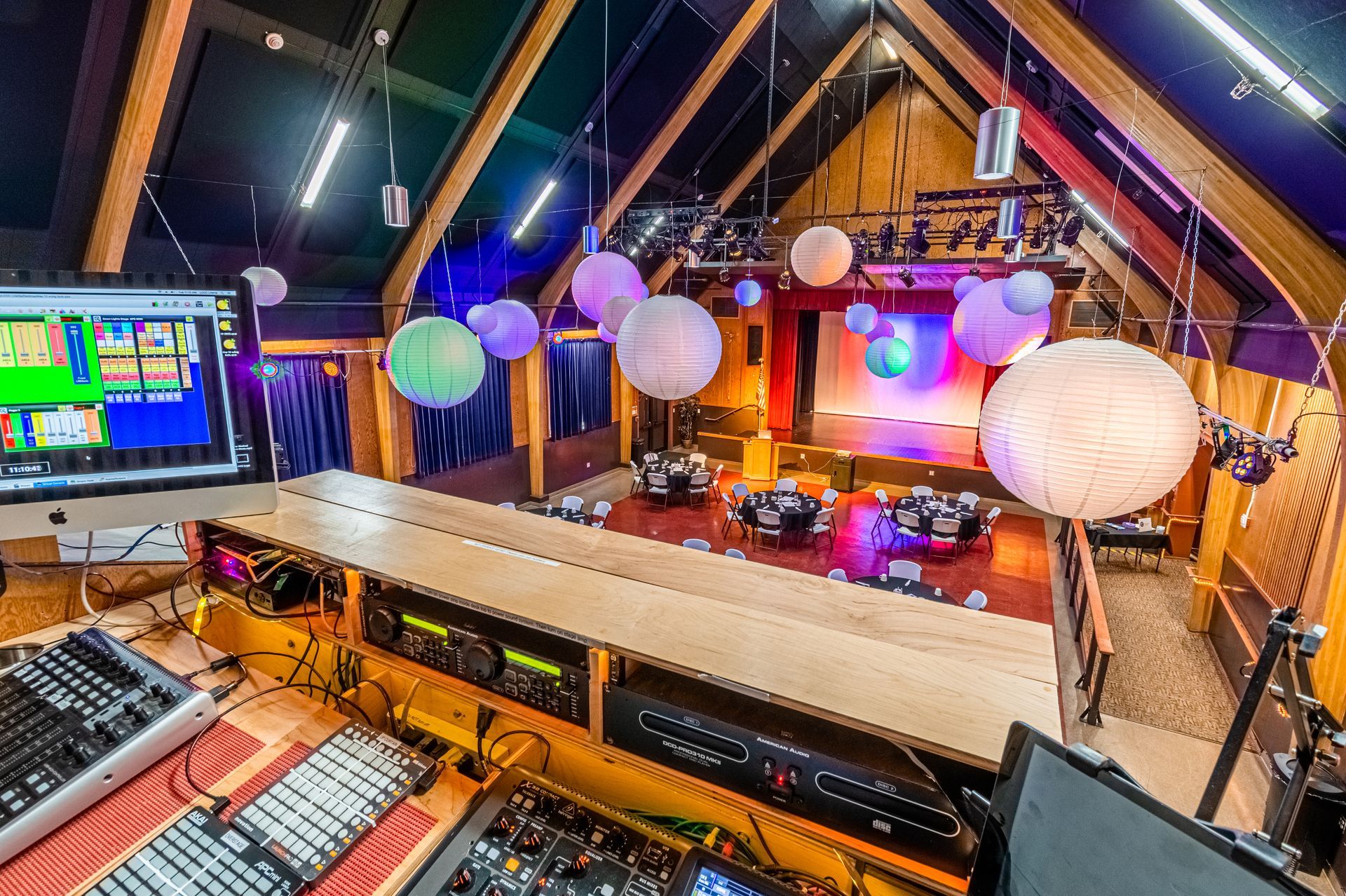 An aerial view of a stage with lanterns hanging from the ceiling.