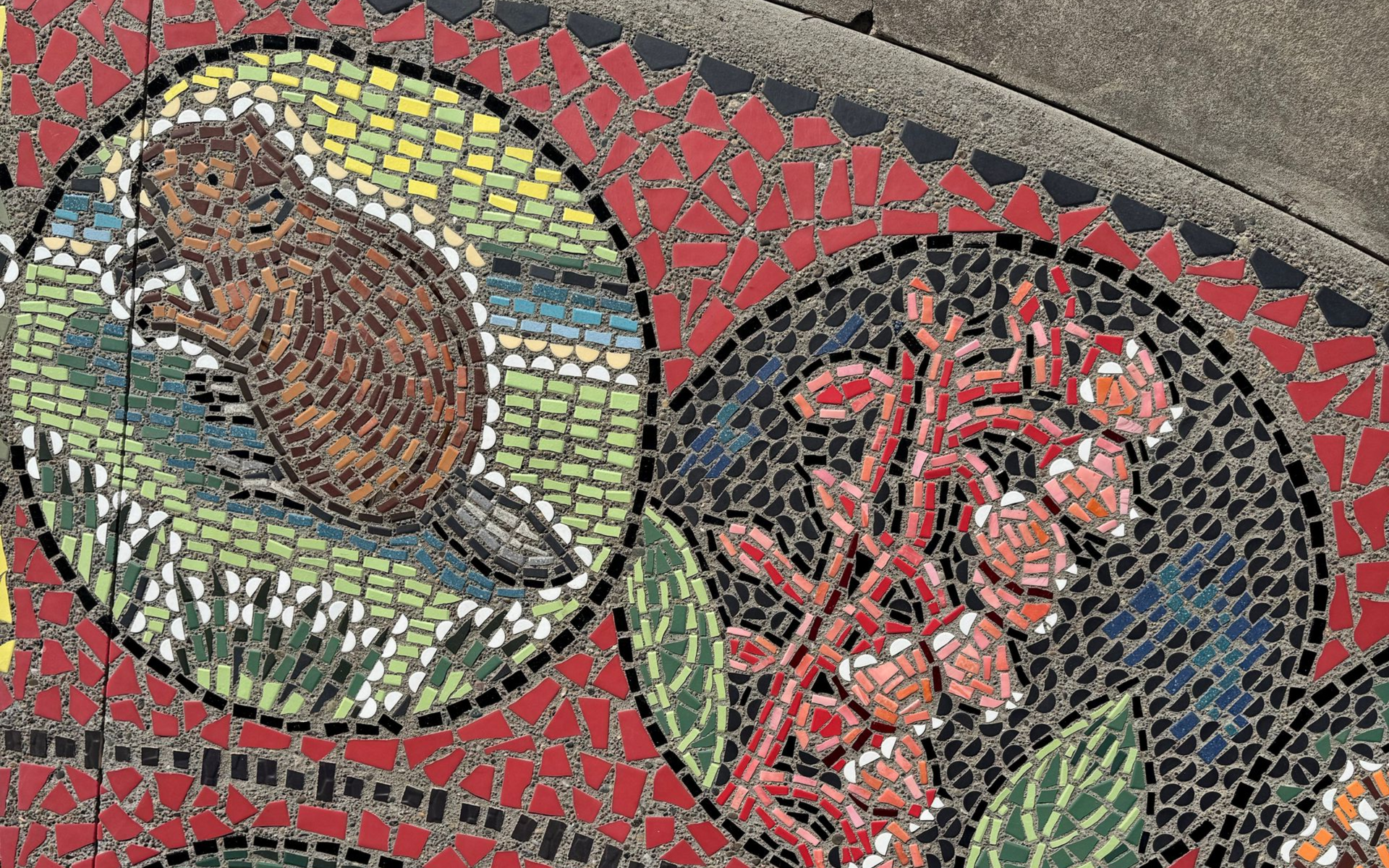 A close up of a mosaic of a beaver and a manzanita flower.