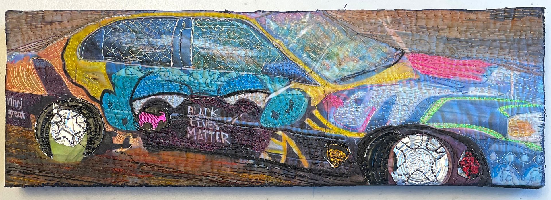 A painting of a car with graffiti on it is on a wooden board.