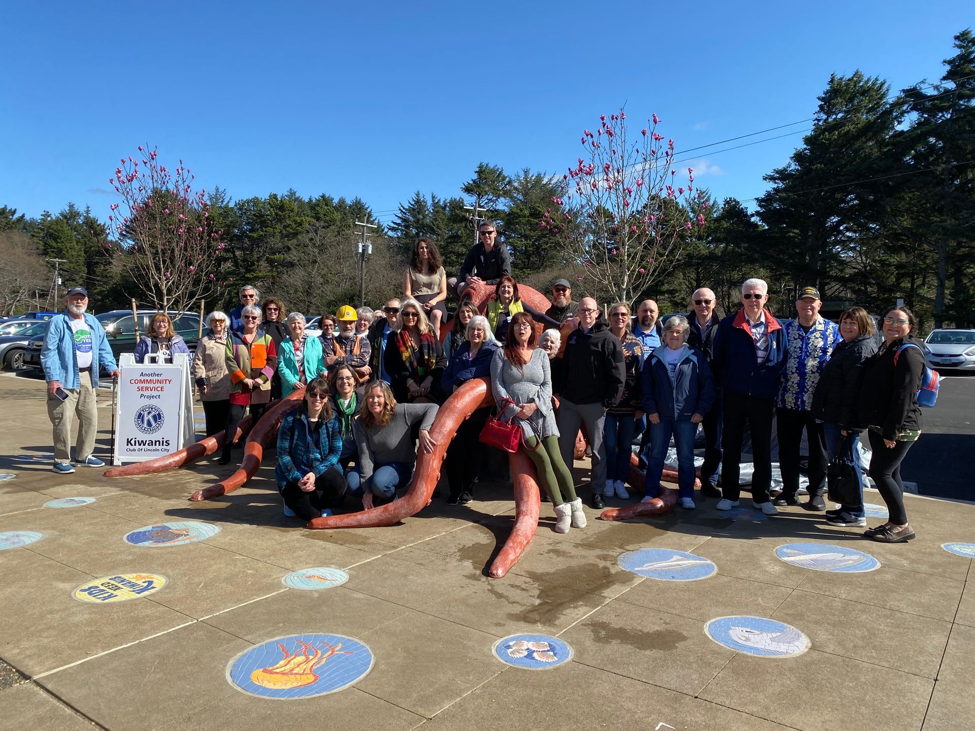 A group of people are posing for a picture in front of a playground.