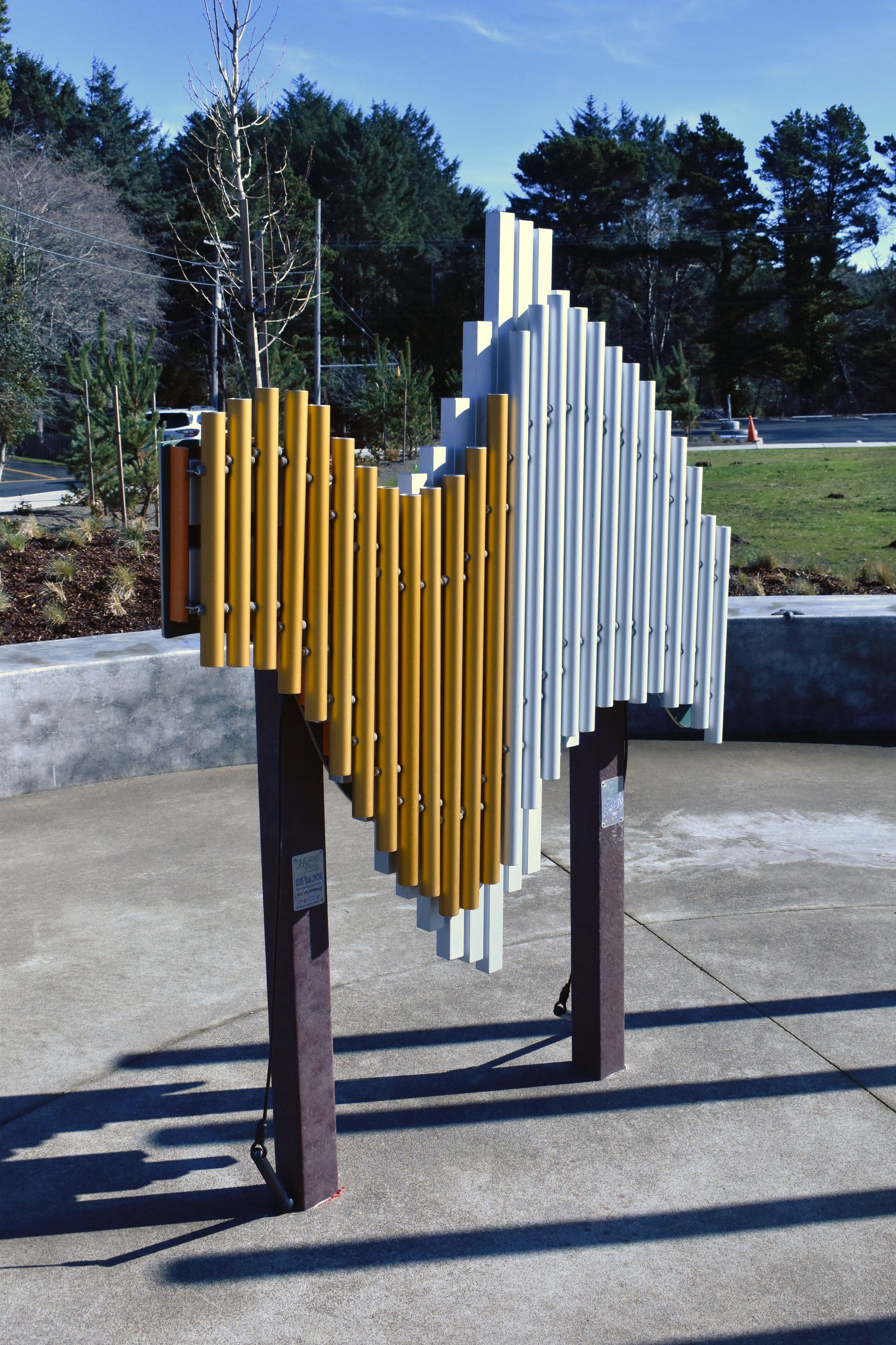 A yellow and white sculpture is sitting on a sidewalk