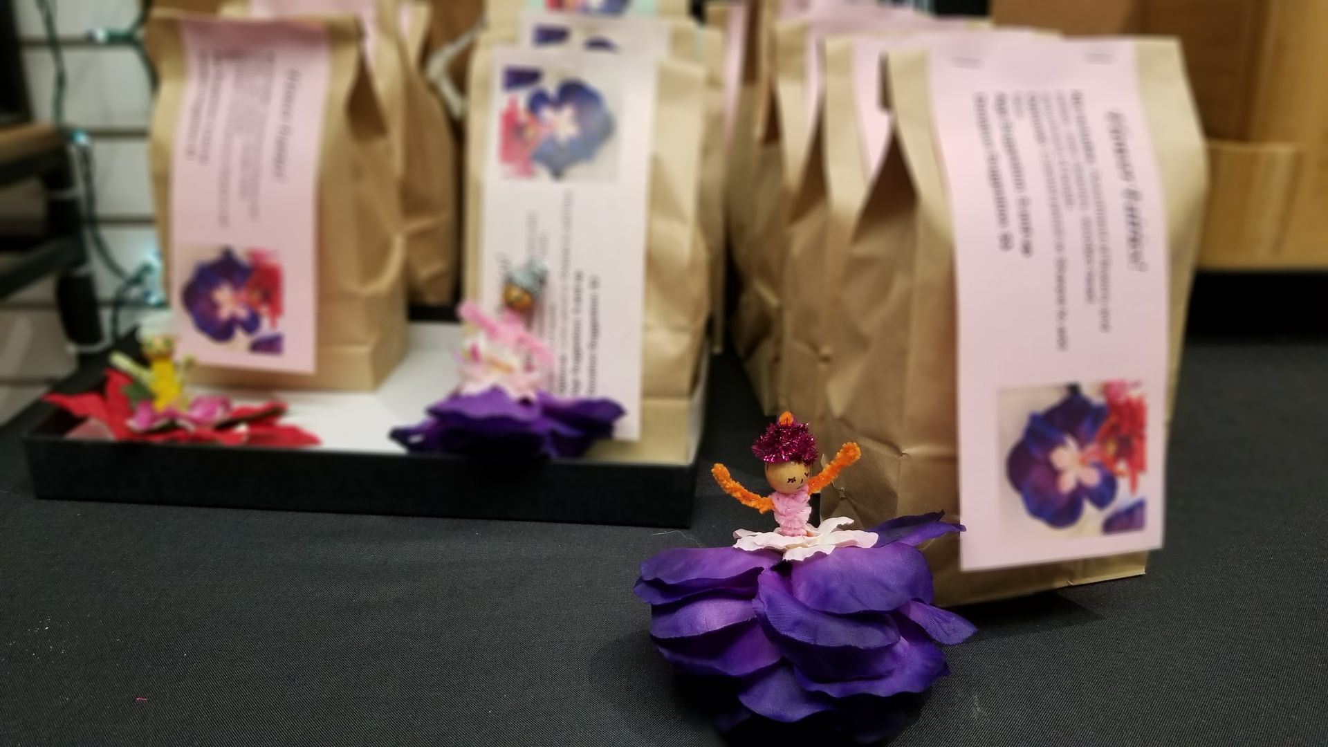 A bunch of brown bags with purple flowers on them