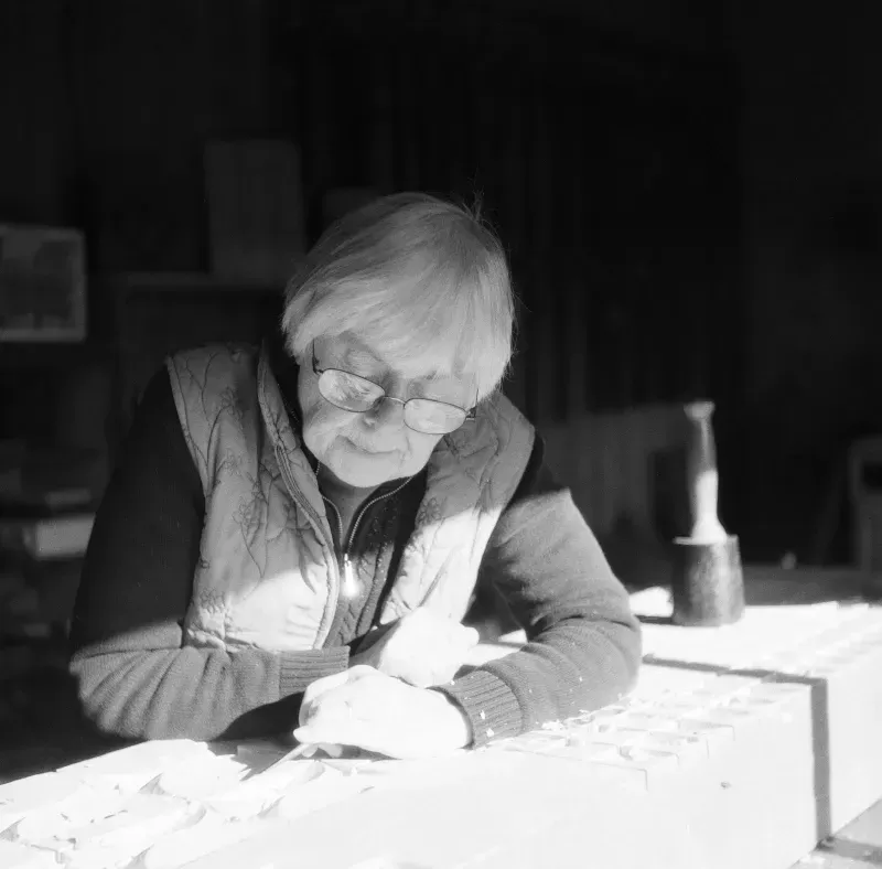 A black and white photo of a woman wearing glasses