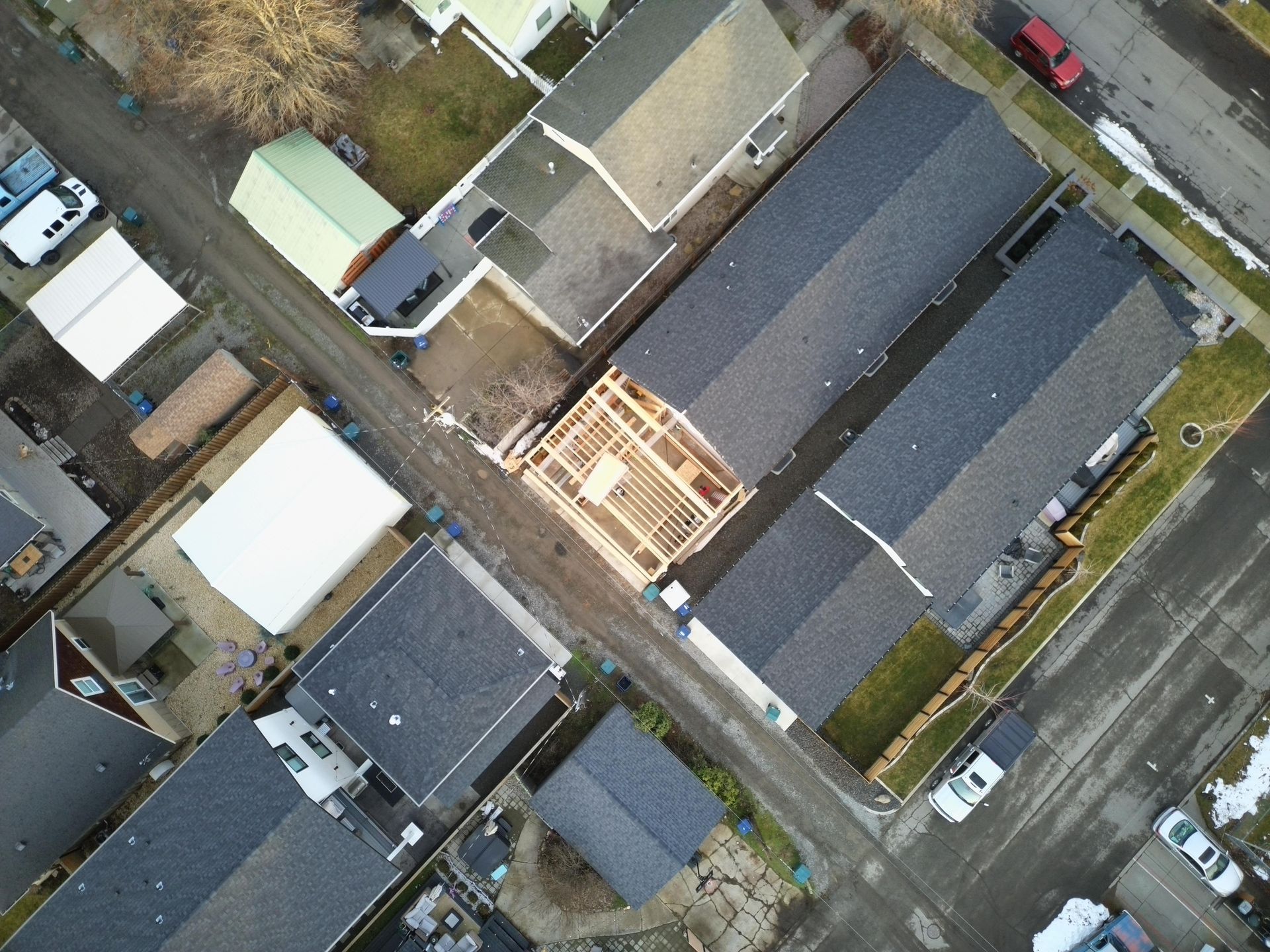 Aerial view of residential neighborhood with houses and a building under construction.