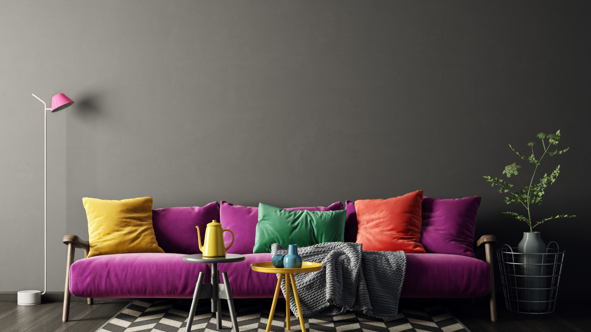 A living room with a purple couch and colorful pillows.