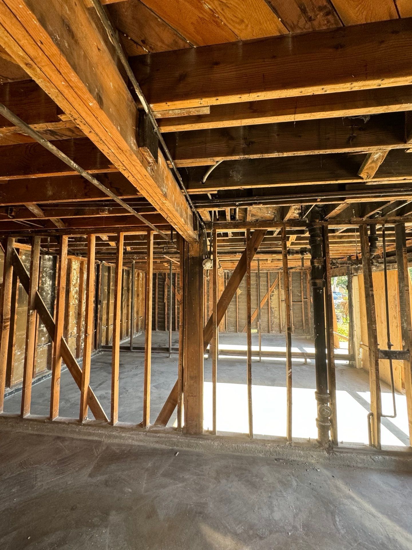 The inside of a house under construction with wooden beams in Huntington Beach.