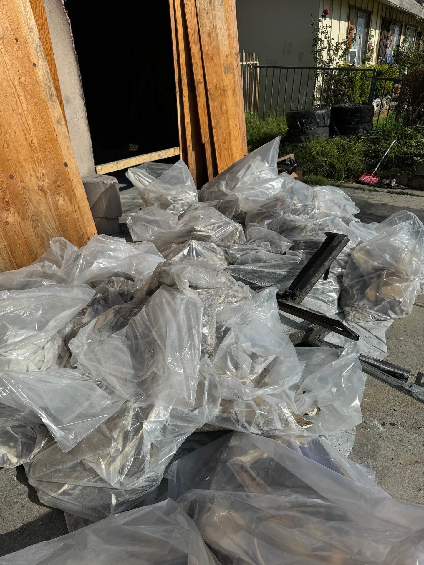 A pile of plastic bags sitting on the ground in front of a building in Huntington Beach.