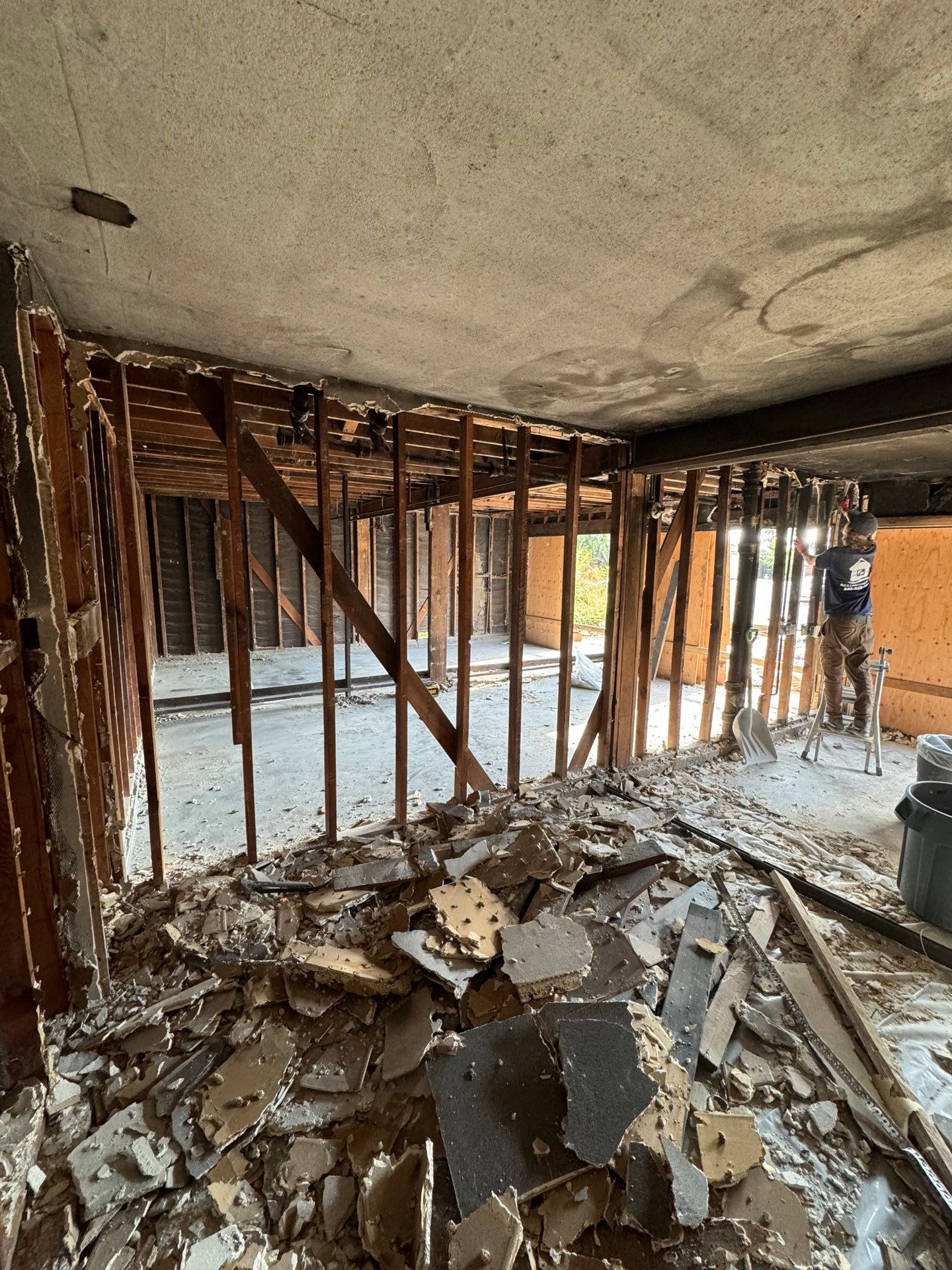 The inside of a building under construction with a pile of rubble on the floor  in Huntington Beach.