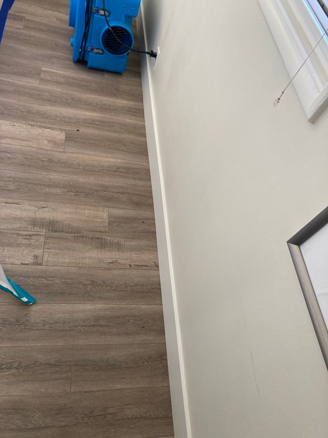 A room with a wooden floor and a white wall in Huntington Beach.