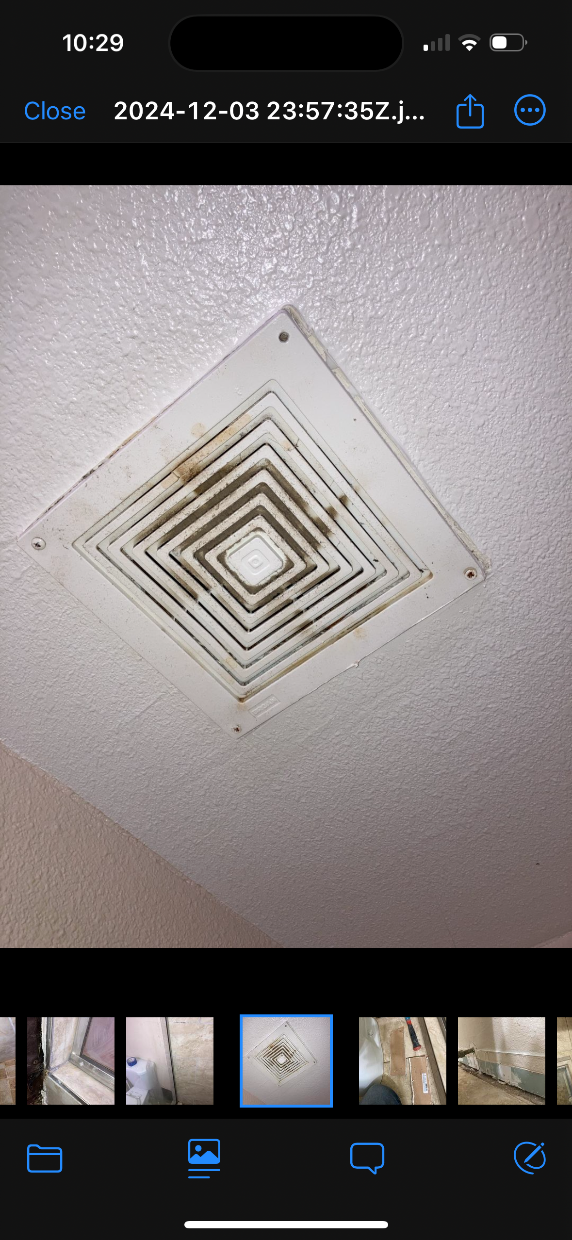 A picture of a ceiling fan on a cell phone.