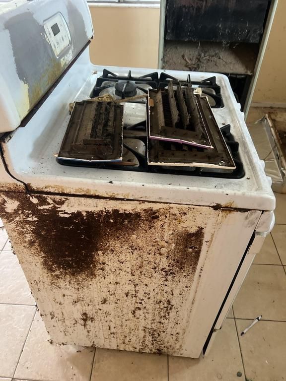 A dirty stove with a lot of stains on it