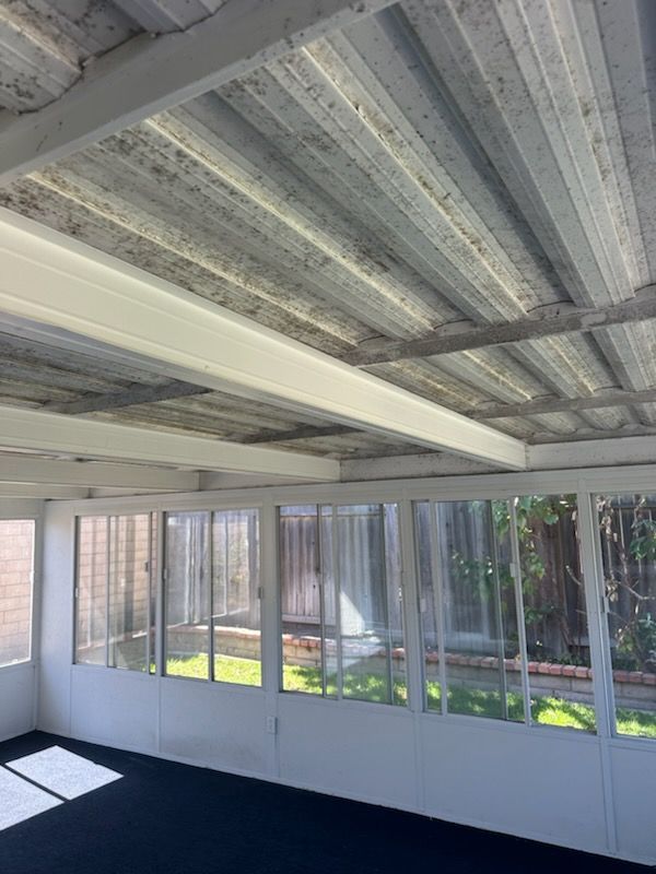 A room with a lot of windows and a ceiling