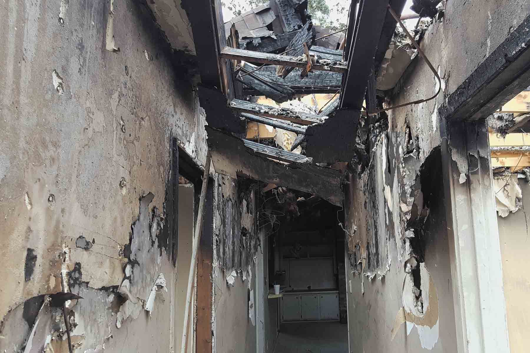 A hallway in a building that has been damaged by fire in Orange, CA.