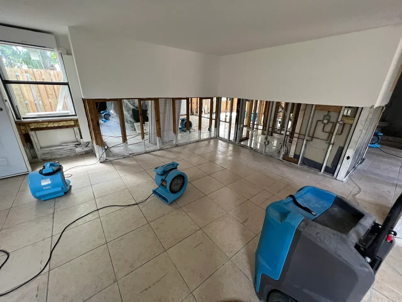A room with a lot of windows and a vacuum cleaner in it in Tustin, CA.
