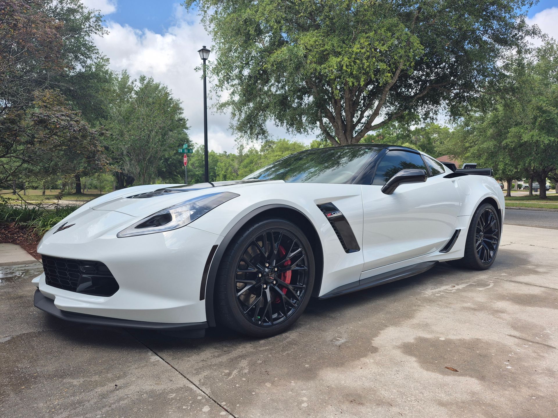 A white corvette zr1 is parked in a parking lot.