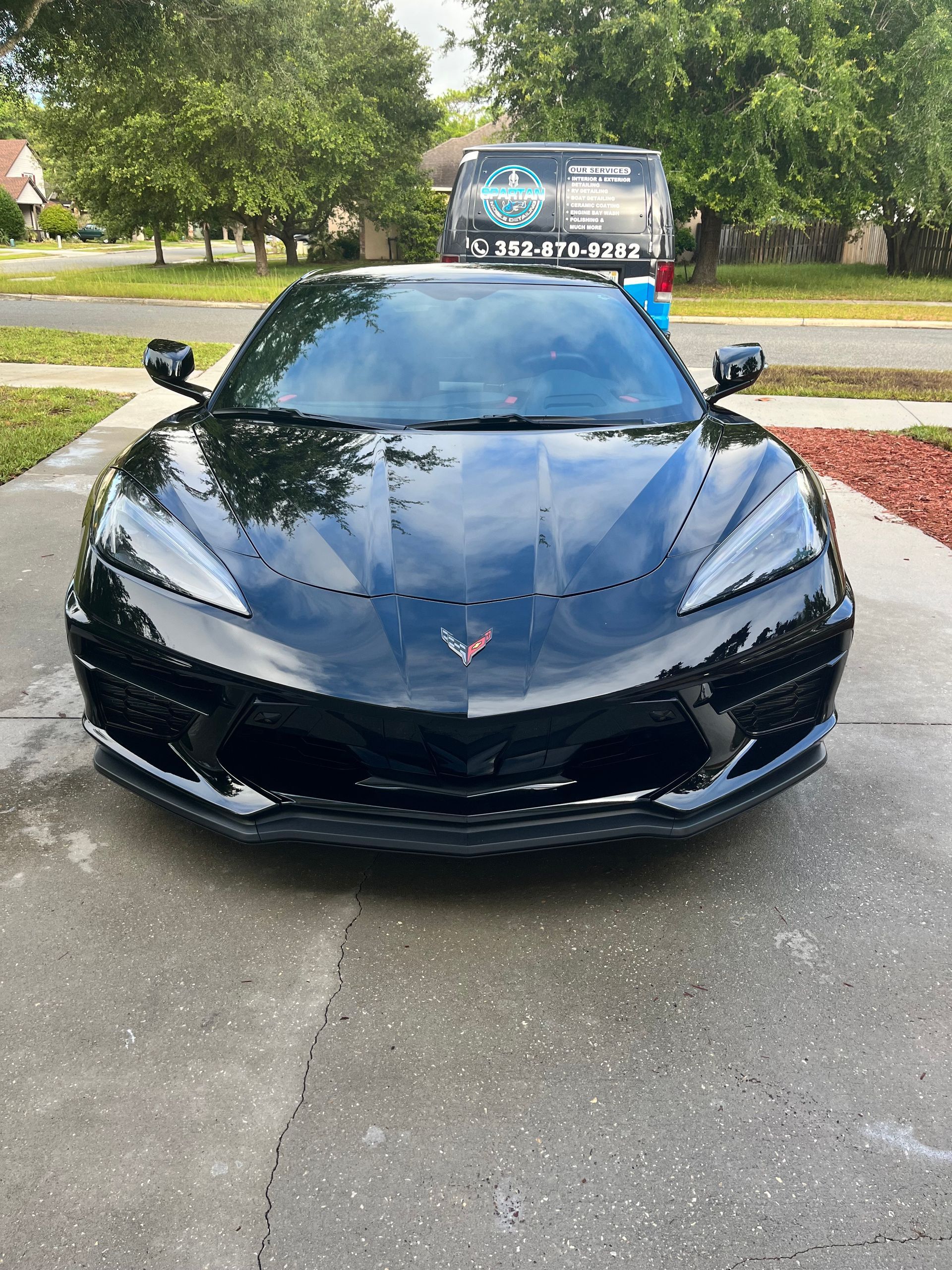 A black sports car is parked on the side of the road.