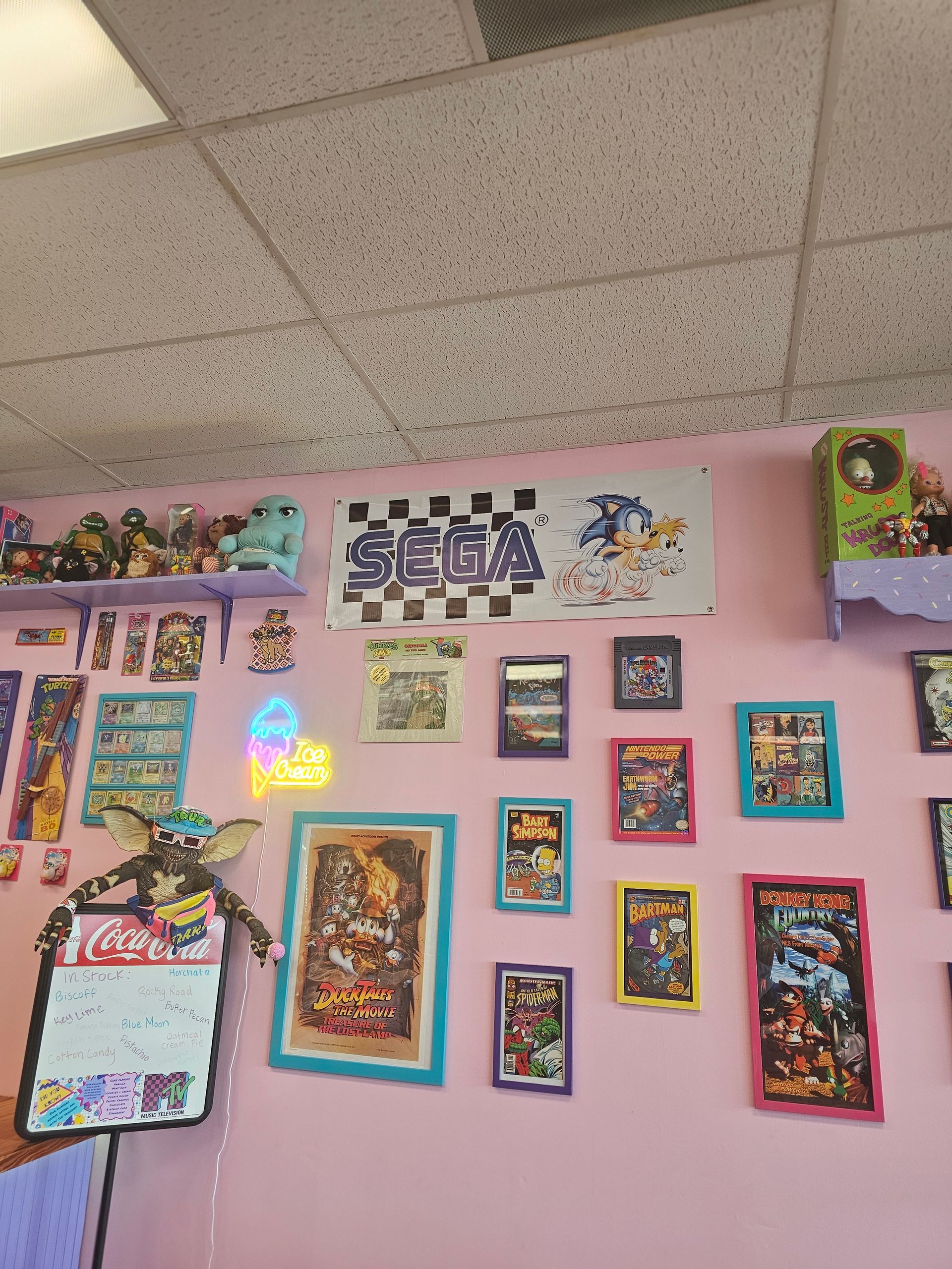 A pink wall with a sign that says sega on it