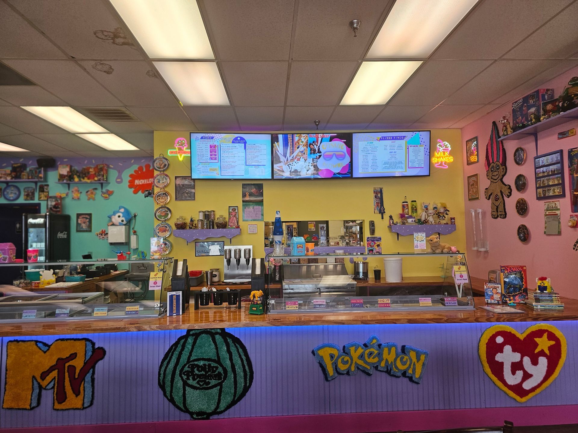 A restaurant with a pokemon , mtv , and ty logo on the counter.