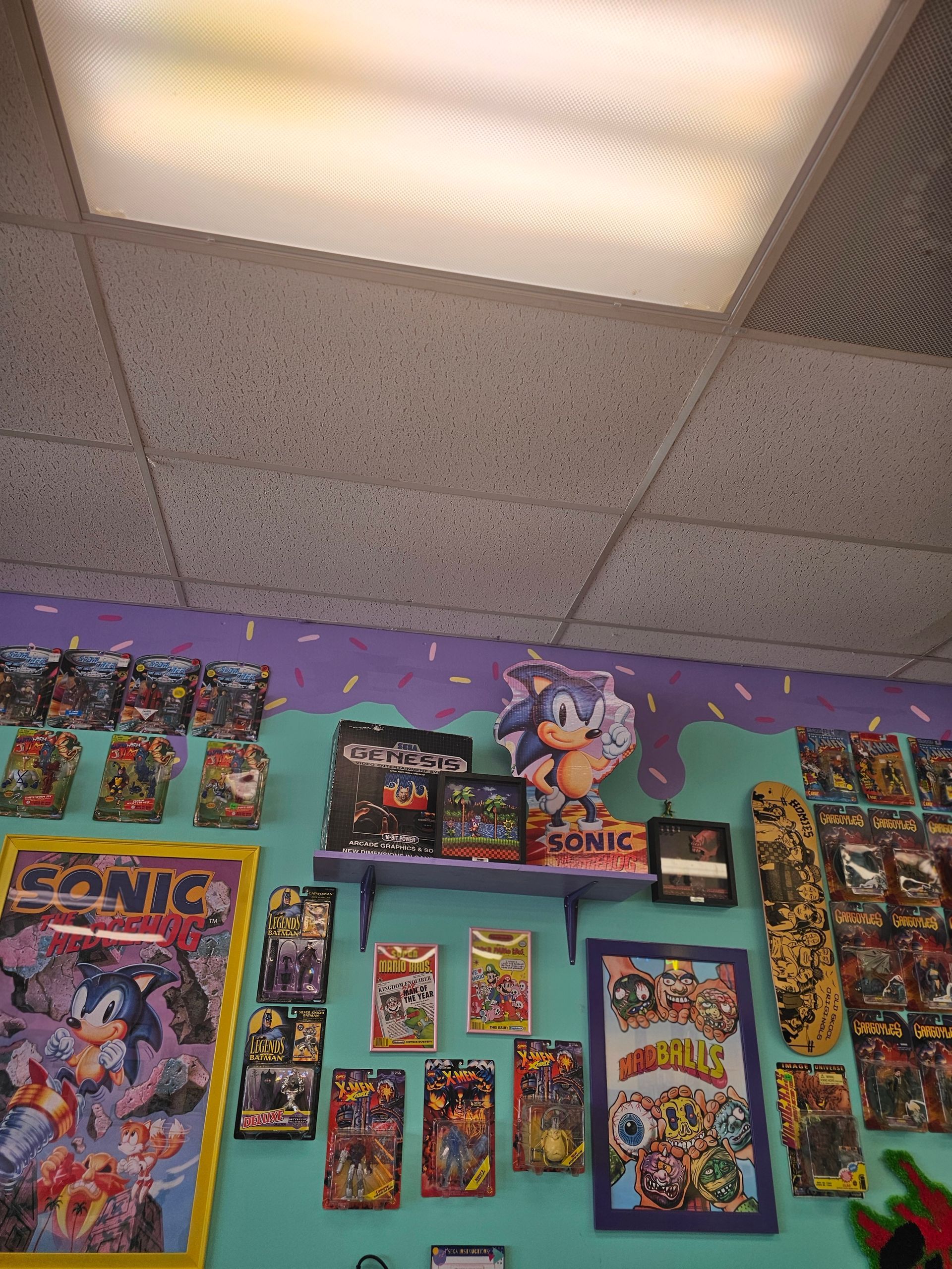 A sonic the hedgehog poster hangs on a wall