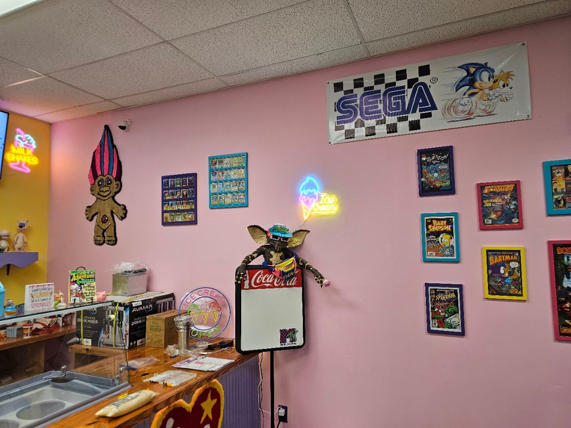 A pink wall with a sign that says sega on it
