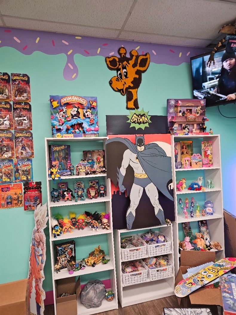 A room filled with lots of toys and a picture of batman