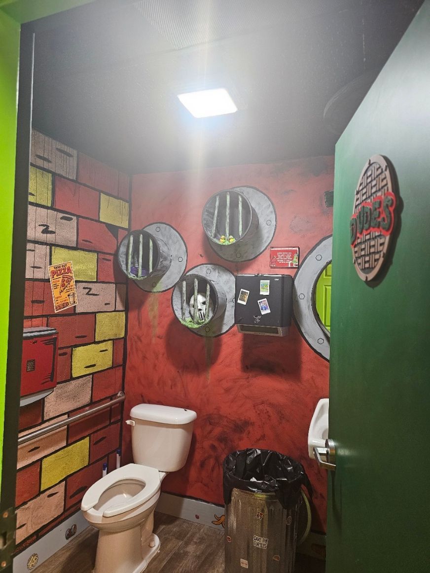A bathroom with a toilet and a green door