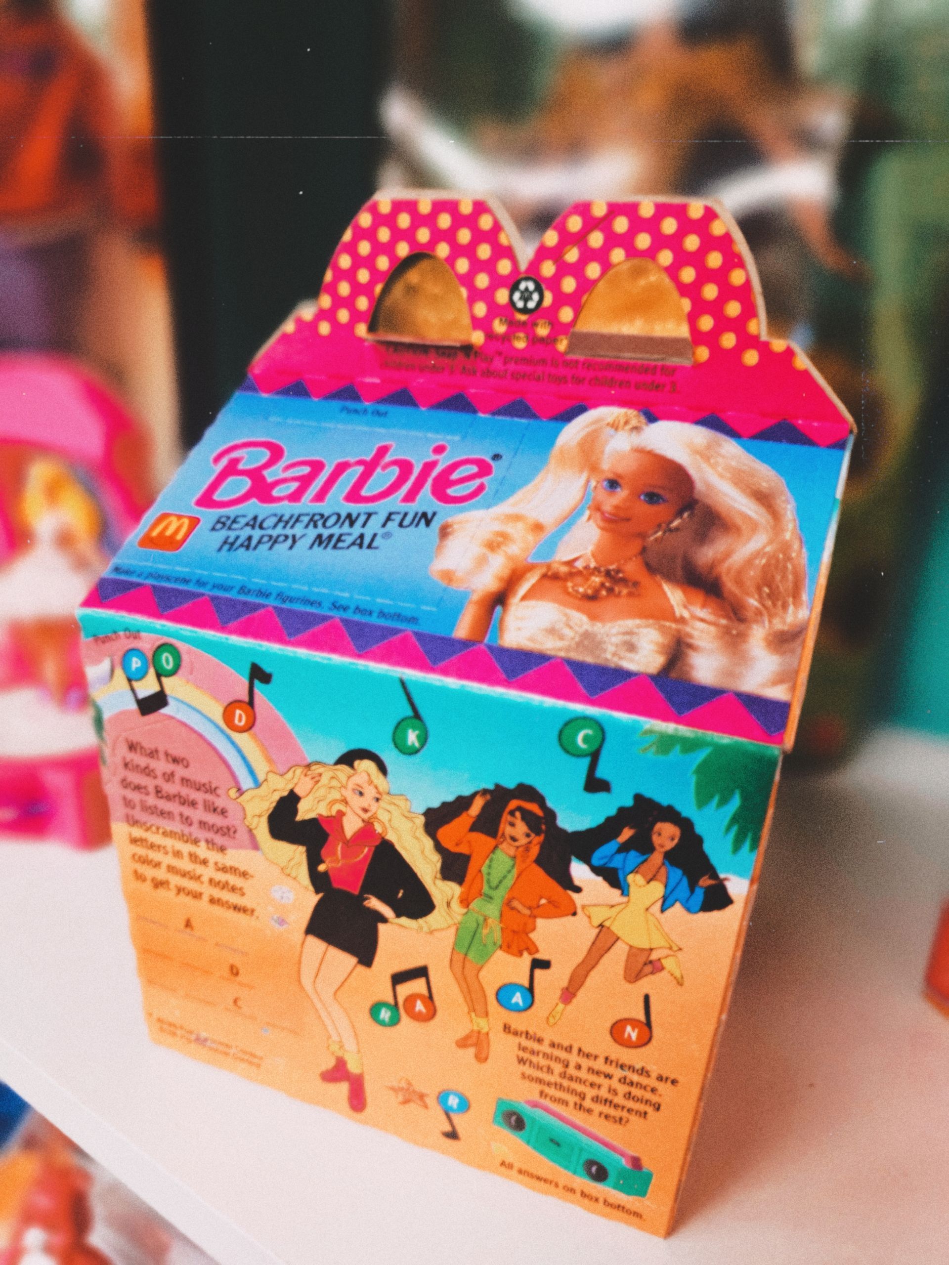 A mcdonald 's happy meal box with a barbie doll inside