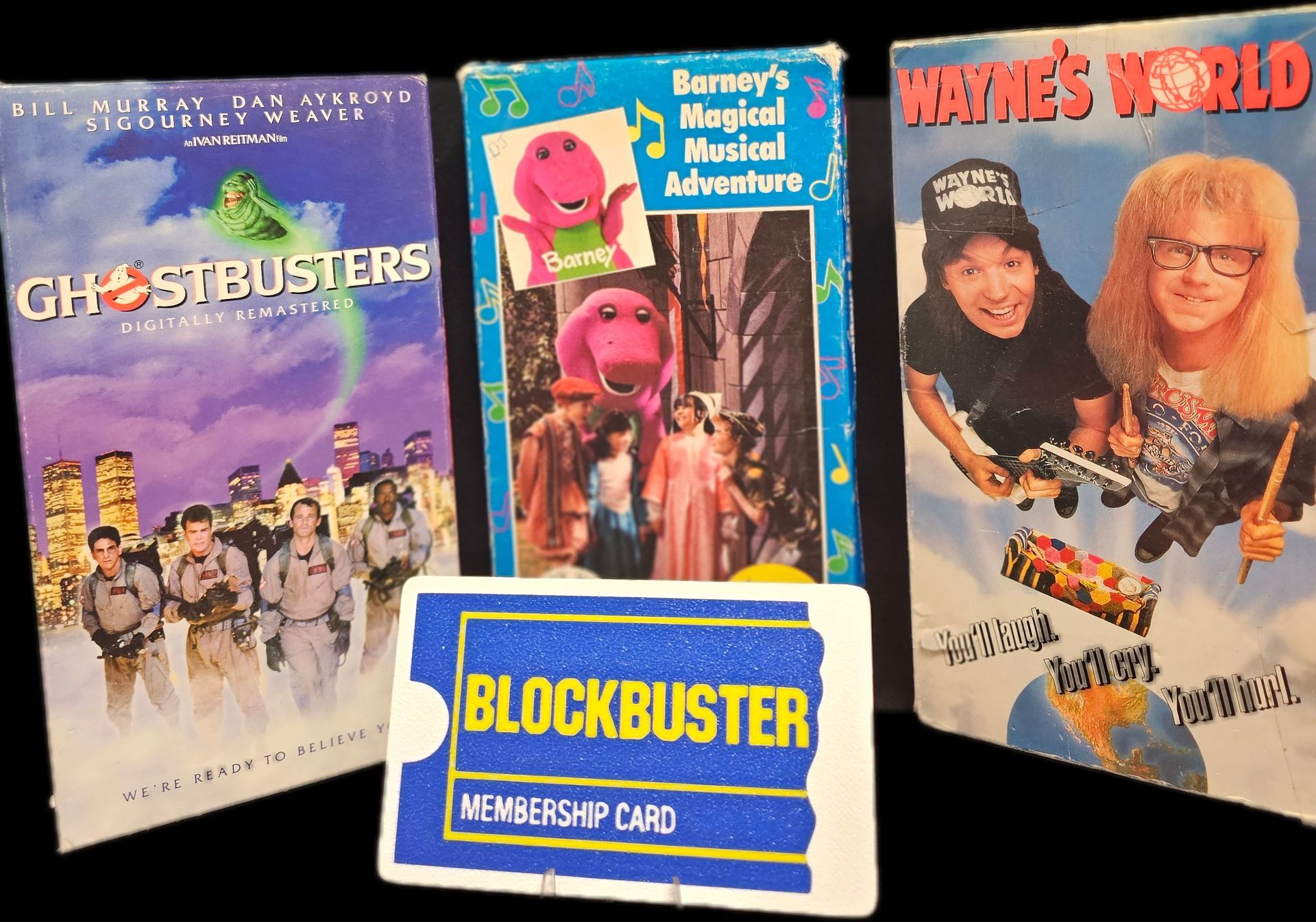 A blockbuster membership card sits next to a ghostbusters dvd