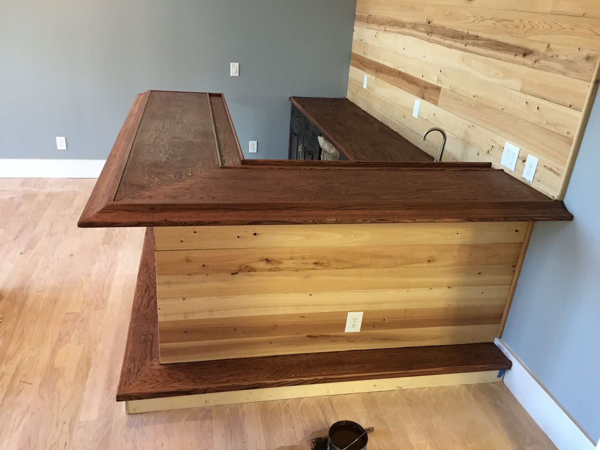 A wooden wheelchair ramp leading up to the front entrance of a house.