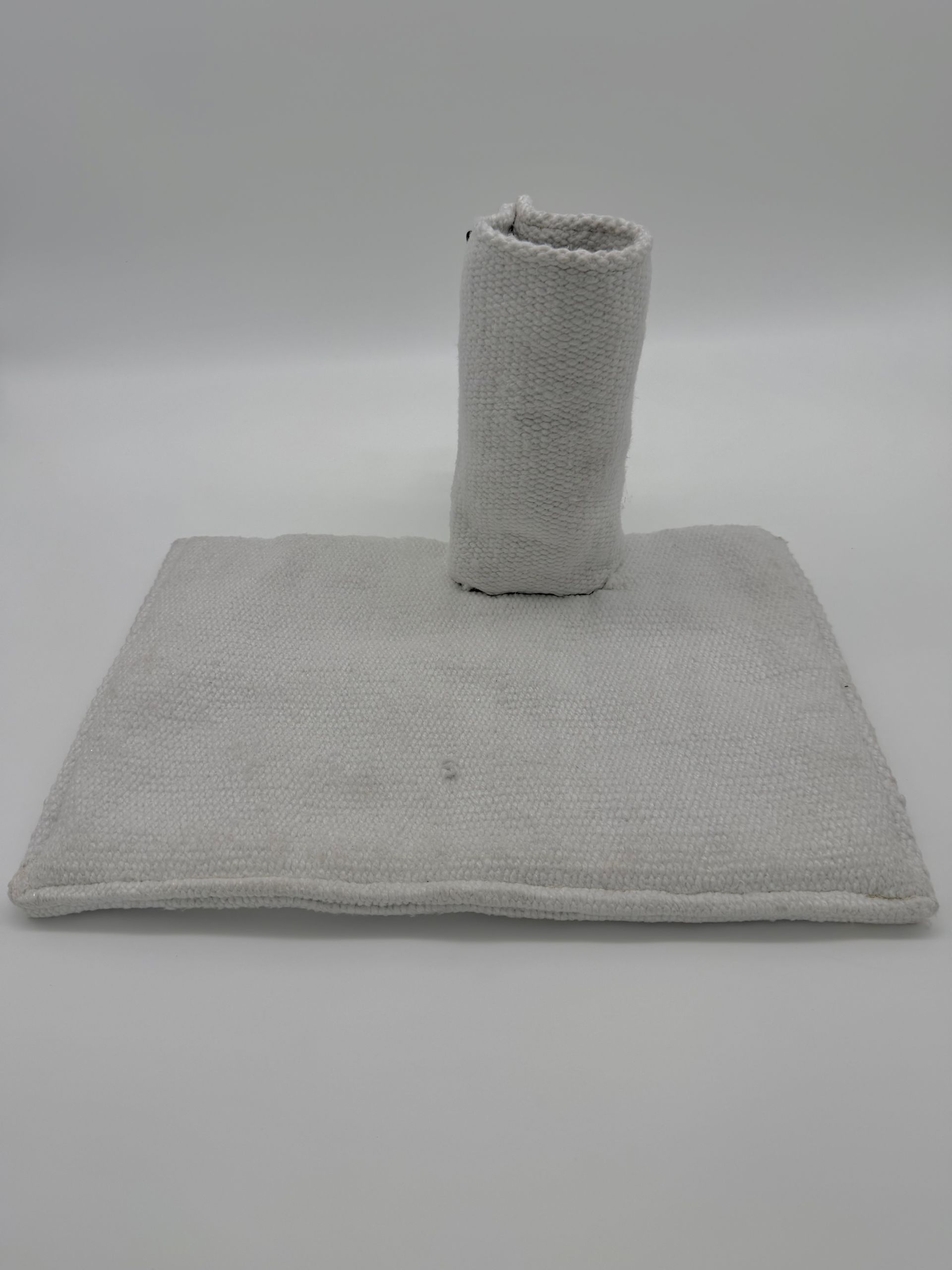 Gray cat scratching post with a square base and vertical scratching column