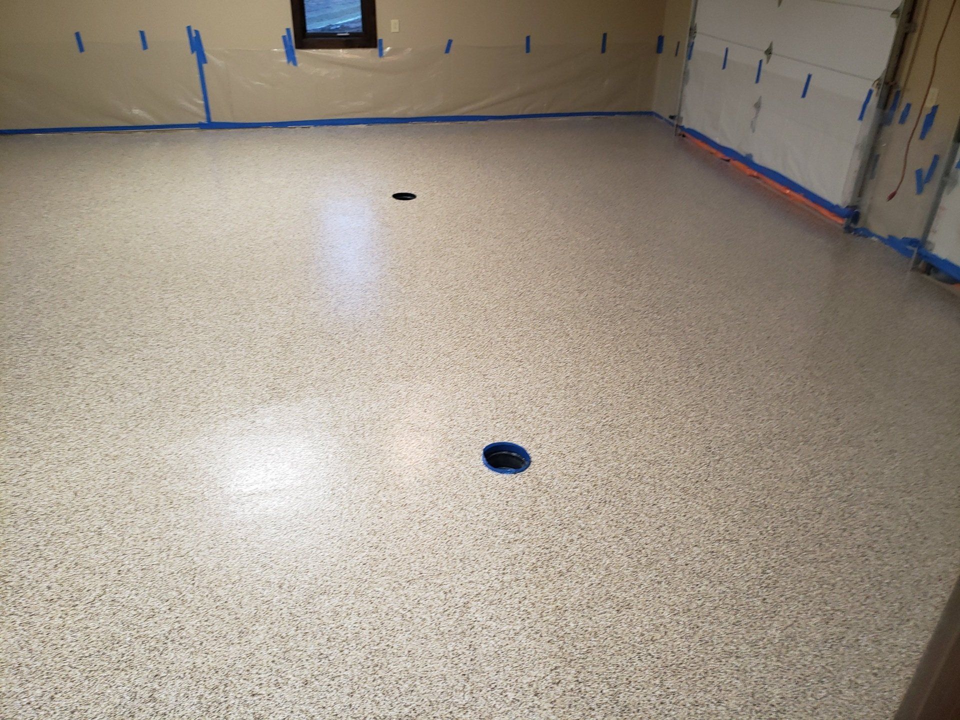 A garage floor with a hole in the middle of it