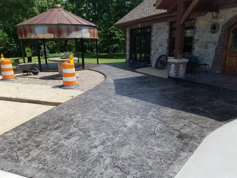 A concrete driveway is being built in front of a house.