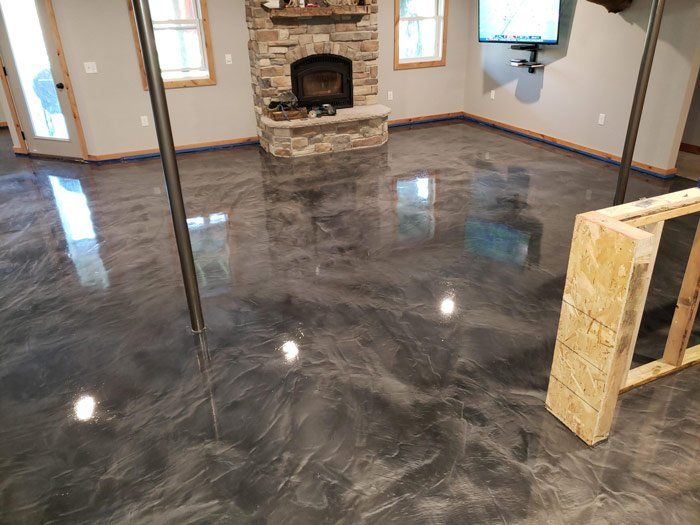 A living room with a shiny metallic floor and a fireplace.