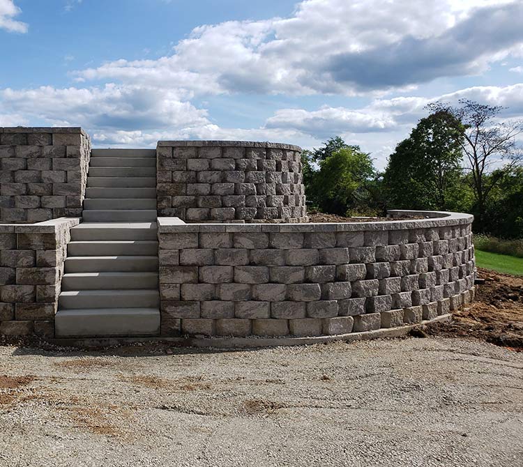 A brick wall with stairs leading up to it
