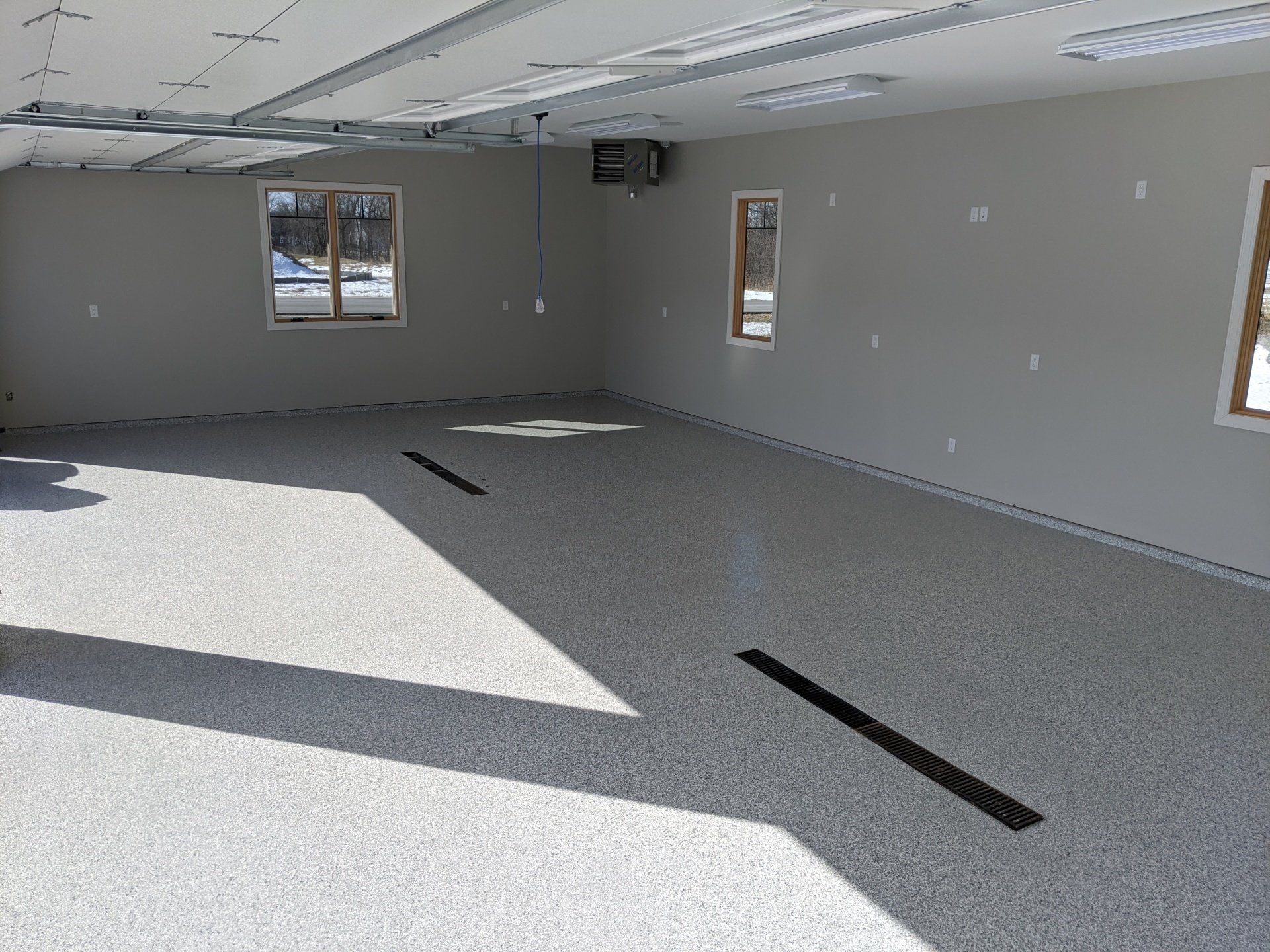 An empty garage with a black line on the floor