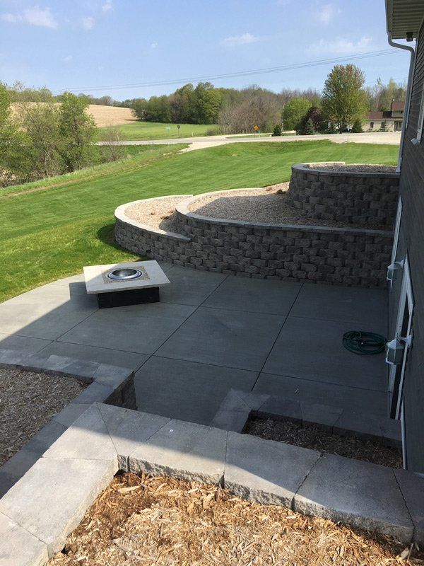 There is a fire pit in the middle of the patio.